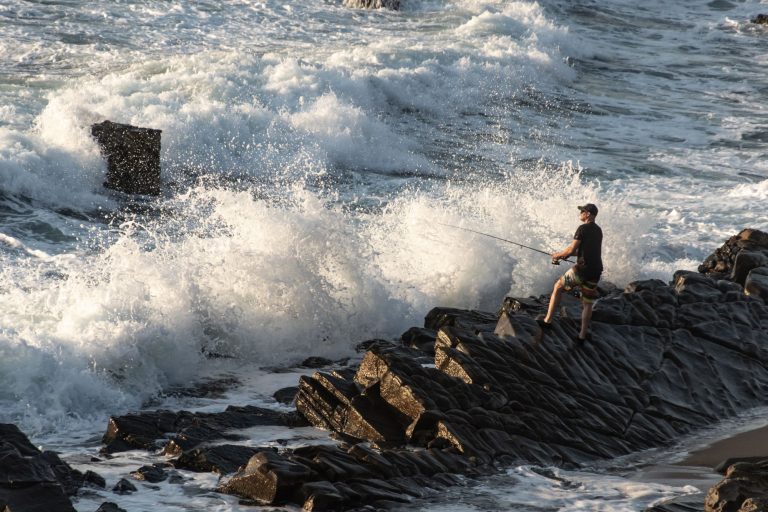 Man Surf Fishing at a Coast