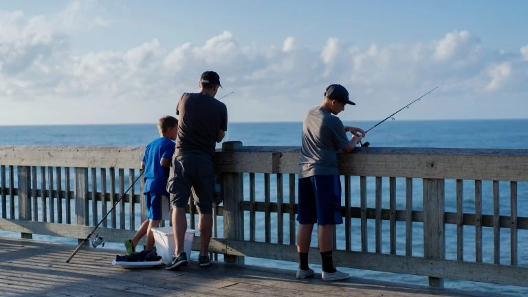 Father and Children Fishing at a Dock