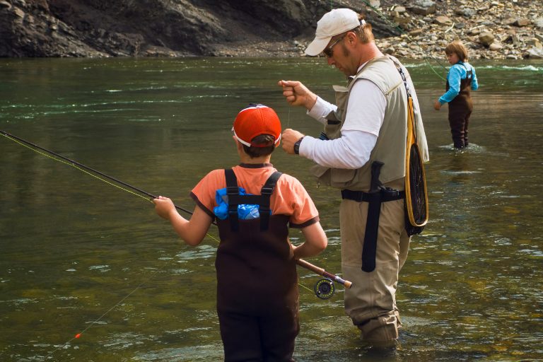 Man Teaching Child to Fish