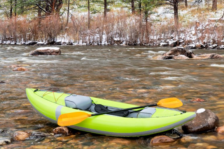 Green Inflatable Kayak on a River