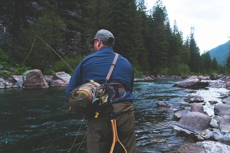 Man Fishing at a River with a Waist Bag