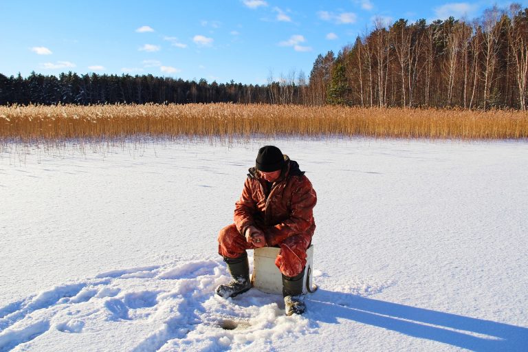 Man Ice Fishing at a Snowfield