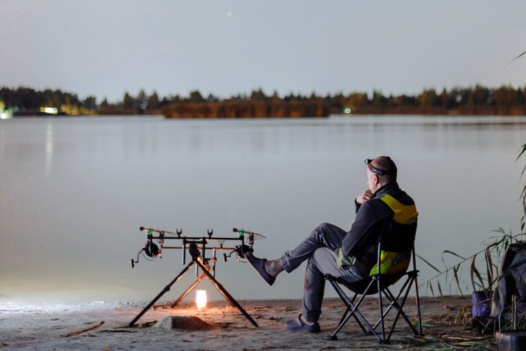 Man Sitting Near Fishing Rods