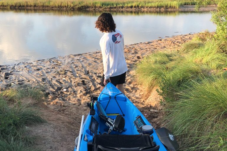 Person Dragging a Kayak to the Water