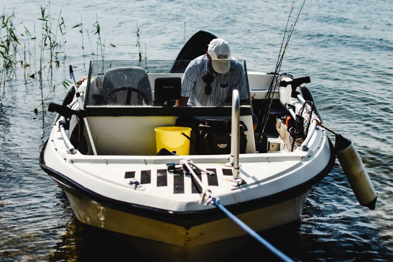 Man Sitting in a Docked Boat
