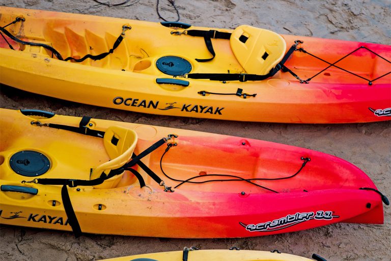 Red and Yellow Sit on Top Kayaks on a Beach