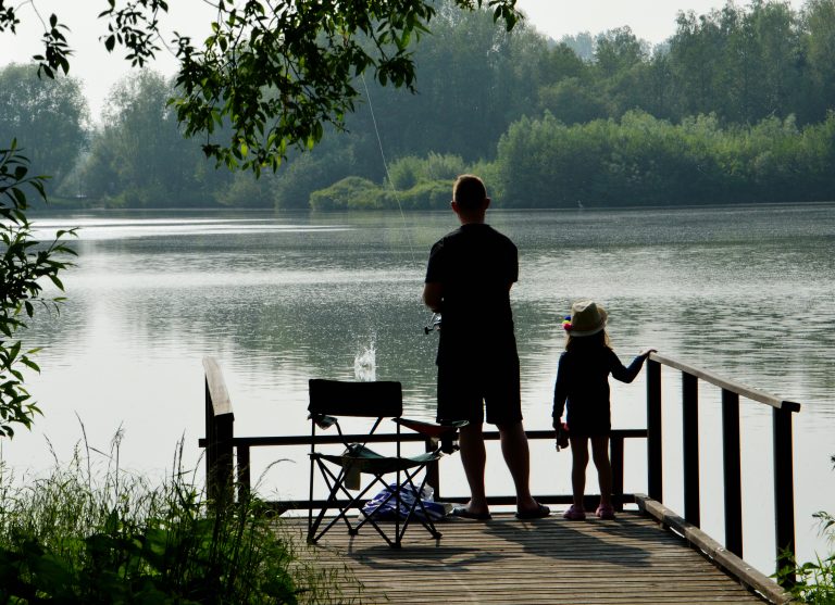 Man and Child Fishing at a Lake