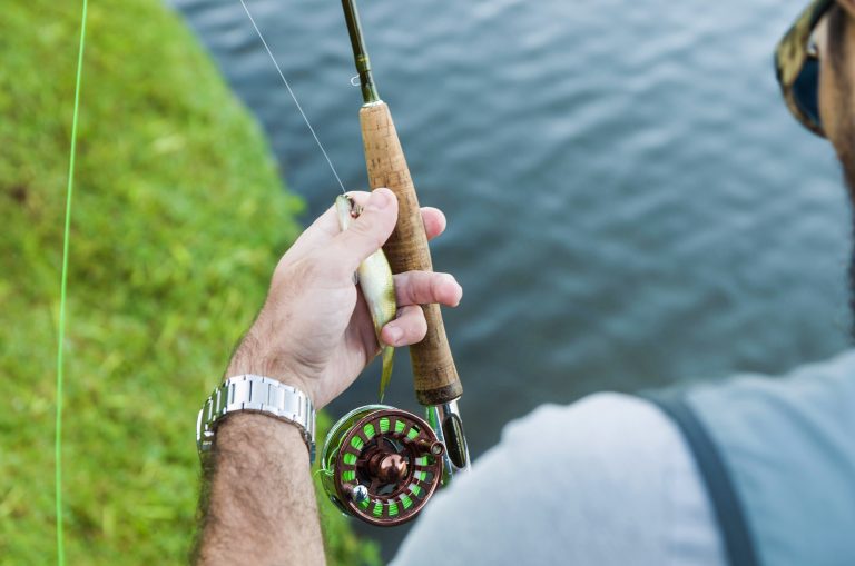 Fisherman Holding a Rod with a Lure
